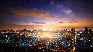 電子回路のような光のラインが広がる夜の近未来都市を上空から見た背景素材