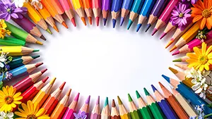 カラフルな色鉛筆と色とりどりの花が楕円形に並んだフレームイラスト