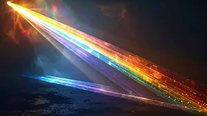 暗い背景の中でプリズムを通ったような鋭い虹色の光線が斜めに差し込んでいる様子