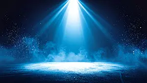 Dark stage background with blue spotlights and smoke creating a mystical atmosphere