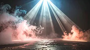 Dramatic and cool monochrome background illustration with sharp light rays cutting through smoke in the darkness
