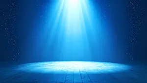 深い青色の空間に上から光が差し込み気泡のような粒子が漂っている海中のようなステージ